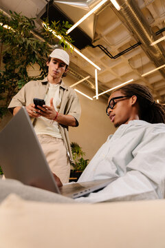 Team working with technological gadgets in modern digital workspace
