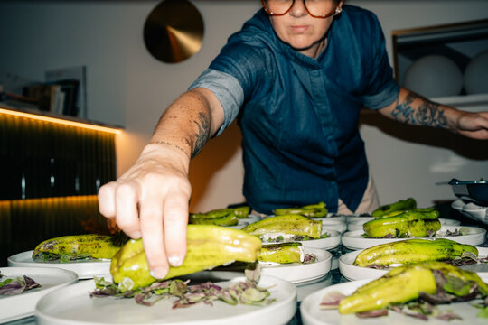 Chef Prepares Green Peppers on Plates in the Kitchen