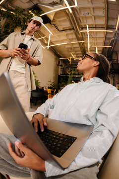 coworkers using a computer and phone as part of mixed work lifestyle