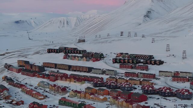 Aerial view of the colorful houses of Longyearbyen nestled in the snowy arctic landscape, Longyearbyen, Svalbard, Svalbard and Jan Mayen.