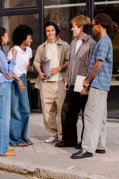 Office workers enjoying a rest break together outside their building