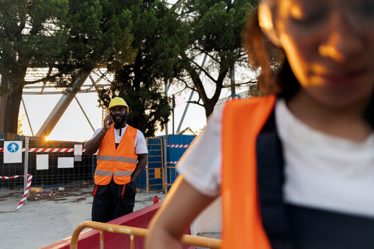 Construction worker talking on phone at urban development site