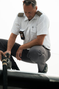 Pilot Refuelling Aircraft On Top Of Wing