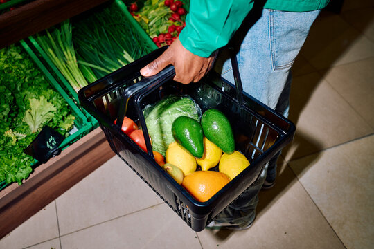 Black Man Holding Basket in Grocery Store