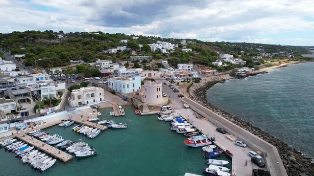 Marina di Pescoluse, Puglia &ndash; Torre Vado &ndash; rotating, ascending aerial shot around the tower at the harbor