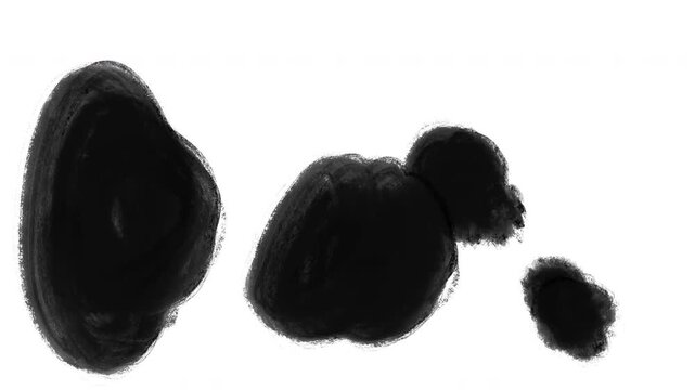 Black ink splashes and stains spreading on white background for creative artistic transitions