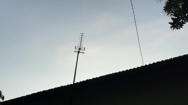 Silhouette Rooftop Antenna Against Clear Evening Sky