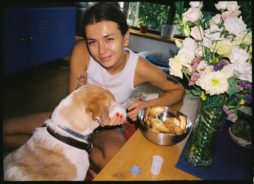 Woman spends time with dog in a cozy indoor setting
