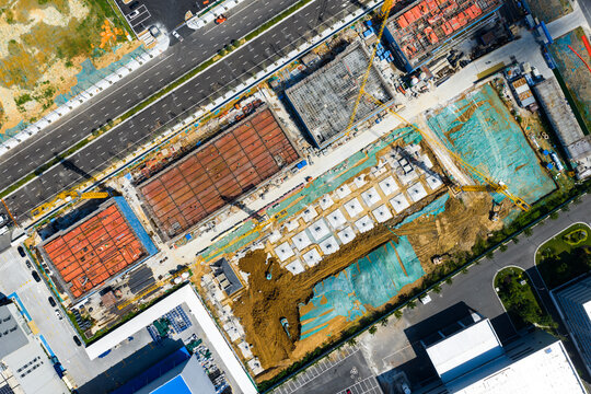 urban construction site with foundation work and cranes