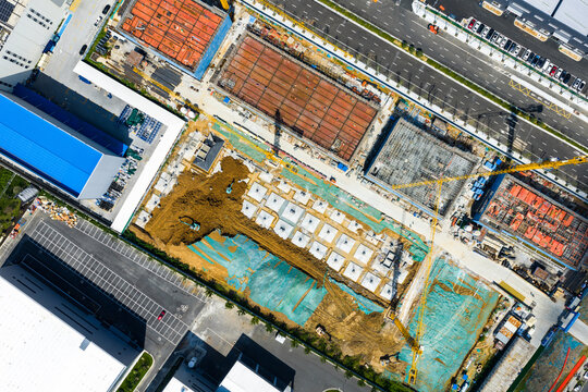 urban construction site with foundation work and cranes