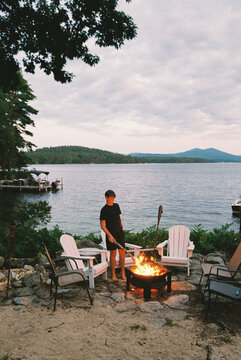 Young boy film portrait at lake bonfire