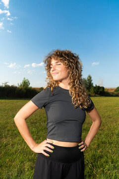 Woman enjoys lifestyle in open field under blue sky