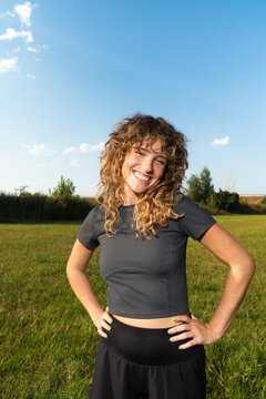 Woman enjoys lifestyle in open field under blue sky
