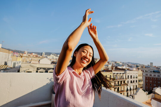 Woman smiling expressing happiness freedom on rooftop