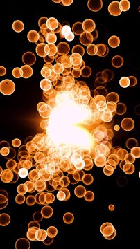 Abstract glow gold bokeh bubble particles flying on black background. Orange red gold bokeh particles dust fly in the air on super slow motion camera 1000 fps.