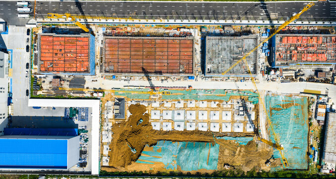 urban construction site with foundation work and cranes