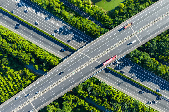 highway interchange curving through lush green forest