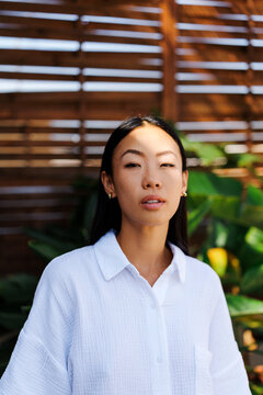 Woman looking at camera with shadow on face