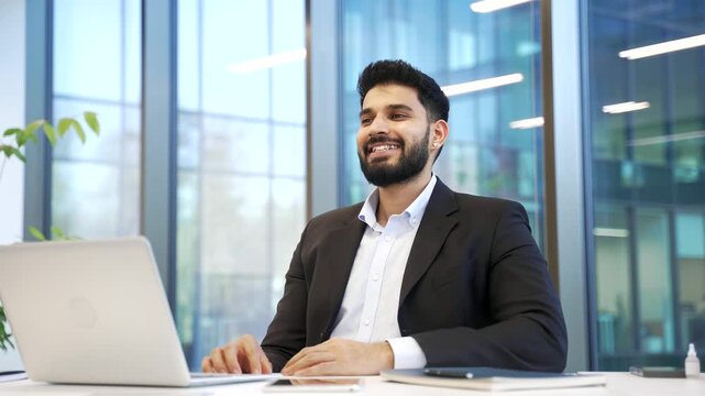 Smiling businessman in formal suit relaxing with eyes closed at workplace in business office. Calm happy employee resting in break at work breathing deeply, feels peace of mind relieve stress. 