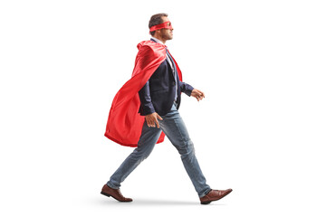 Full length profile shot of a superhero businessman walking © Ljupco Smokovski