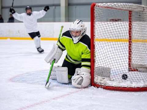 Young ice hockey goalkeeper after conceding a goal, sports pressure, setback and resilience in youth competition