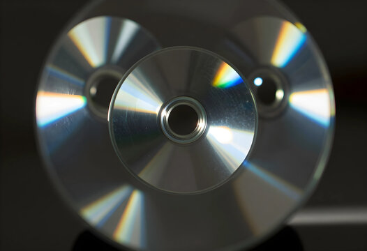 Data storage and digital legacy, compact discs with rainbow light reflection on dark background for technology and information archiving concepts
