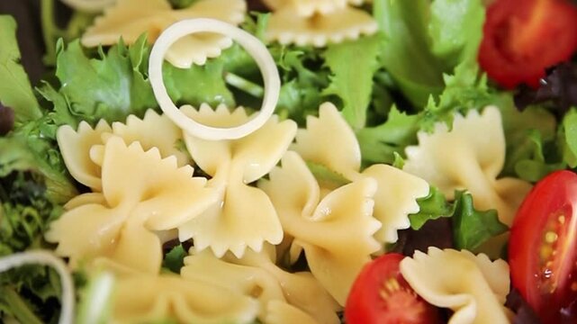 Pasta Salad tomato, green lettuce, farfalle pasta serving size vegetarian and vegan food natural ingredients healthy eating, wholesome tasty dish, snack fresh, gourmet, rustic food background on the t