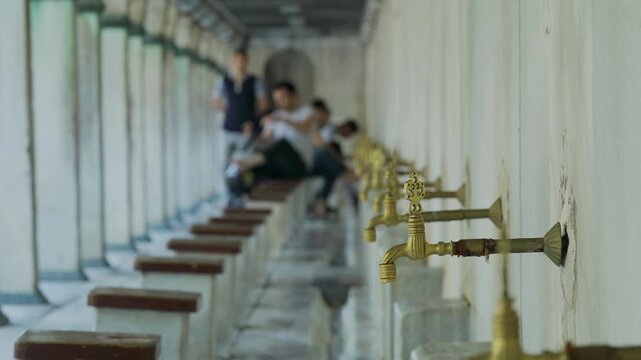 Mosque fountain. silhouette people performing ablution at mosque. 