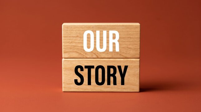 Wooden block with our story text on orange background