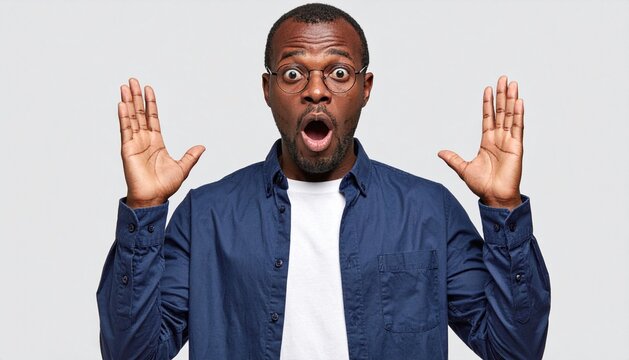 Shocked Black Man with Glasses Raising Hands in Surprise Isolated on Grey Studio Background