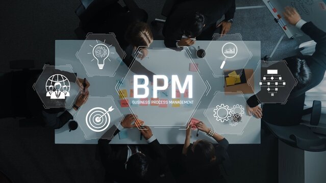 A diverse team collaborates around a table to enhance business process management. Visual elements illustrate innovative ideas and strategy development through teamwork. Raster