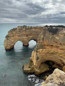 Natural sea arches in coastal cliffs of Algarve, Portugal