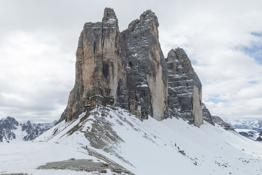 Snow covers the mountain peaks of Tre Cime in Dolomites during winter. The scene shows the beauty of alpine scenery and winter tourism.
