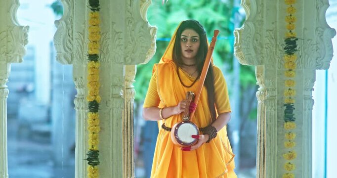 Saint Mirabai Entering a Traditional Hindu Temple and Worshipping Lord Krishna. Rajasthani saint devoted to Krishna performs prayers and devotional rituals inside the temple.