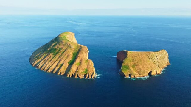 Cabras Islets and Atlantic Ocean at Sunset. Terceira Island, Azores, Portugal. Aerial View. Orbiting