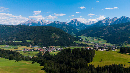 Obraz premium Majestic scenery of rough mountain ridge near grassy hills 