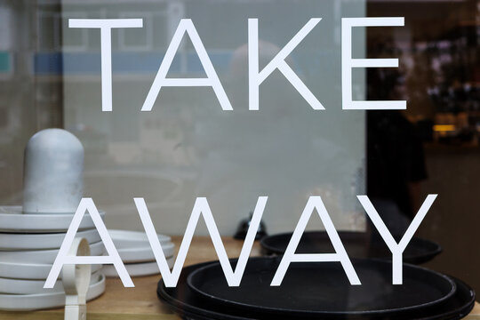 Takeaway food sign on restaurant cafe window, pickup and delivery order concept for dining, hospitality, convenience and modern food service