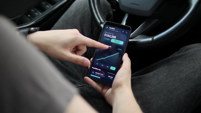 Investor reviews a mobile portfolio dashboard in a parked car, switching performance periods to track long-term growth, digital wealth management and personal finance trends.