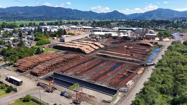 OREGON - 9.2.2026 - Incredible aerial footage circling clockwise around an active lumber mill by an Oregon mountain range.