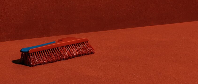 Amber plastic ice scraper on a matching monochrome surface with soft shadows and generous copy space for winter themes