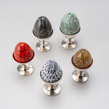 set of five decorative Murano glass eggs with silver-plated metal chalice support.