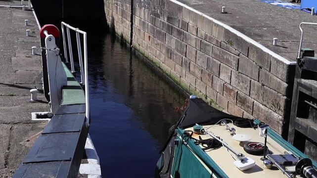 Canal boat on the canal. Boat going through the canal lock gates.  