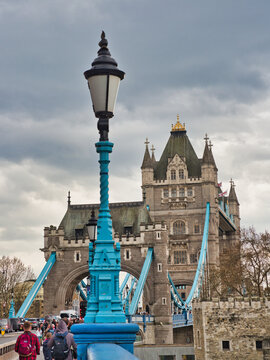 Tower Bridge and Lamppost in London - An iconic view of the historic Tower Bridge and a vibrant blue lamppost in London under a cloudy sky, showcasing British architecture and ur