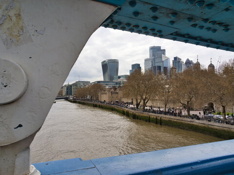 The Shard and Thames River from Tower Br - A view of London's iconic Shard skyscraper and other modern buildings along the River Thames, framed by the blue riveted structure of Tower