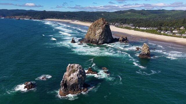 OREGON - 9.2.2026 - Terrific aerial footage circling clockwise around rock formations off the coast of Oregon's Cannon Beach.