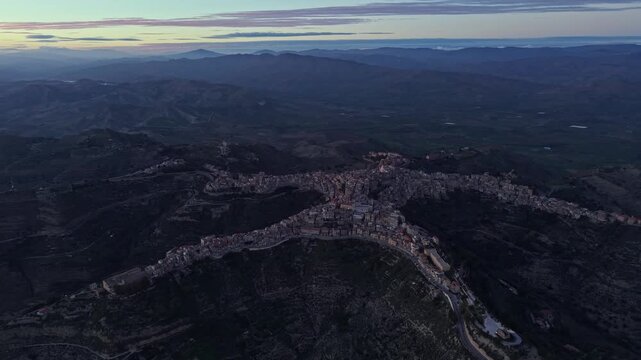 Aerial view of the town of Centuripe, famous for its unique human-like shape, nestled in the hilly landscape of Sicily, Centuripe, Sicily, Italy.