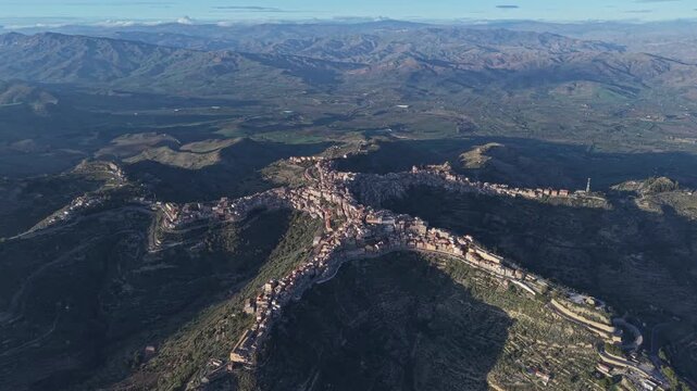 Aerial view of the historic town of Centuripe, known for its unique star-shaped layout, nestled among the rugged hills of the Sicilian landscape, Centuripe, Sicily, Italy.
