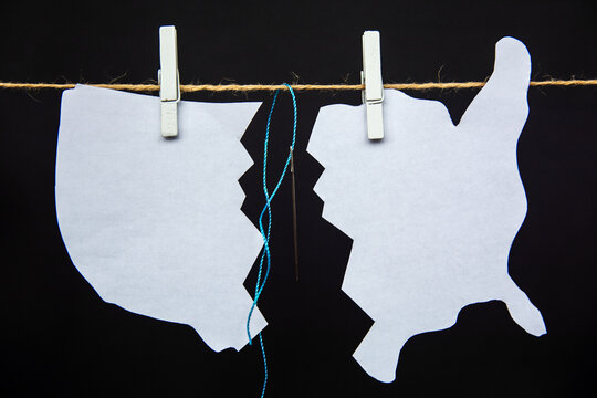 map of america USA is split with scissors - as a symbol of crisis and chaos of division in country