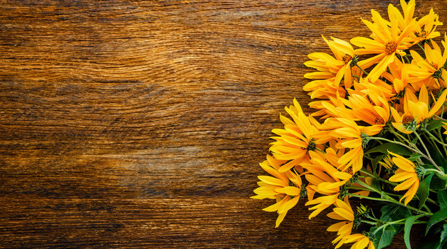 Yellow autumn wild sunflowers bouquet on rustic wooden background with copy space