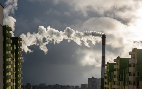 Environmental problem of city air pollution - Industrial construction cranes and building site over Steam and smoke emissions. grunge filter photo	